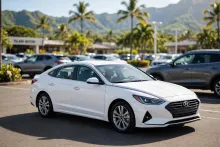 White sedan on a sunny car lot — MilitaryCarLot.com weekly featured vehicle